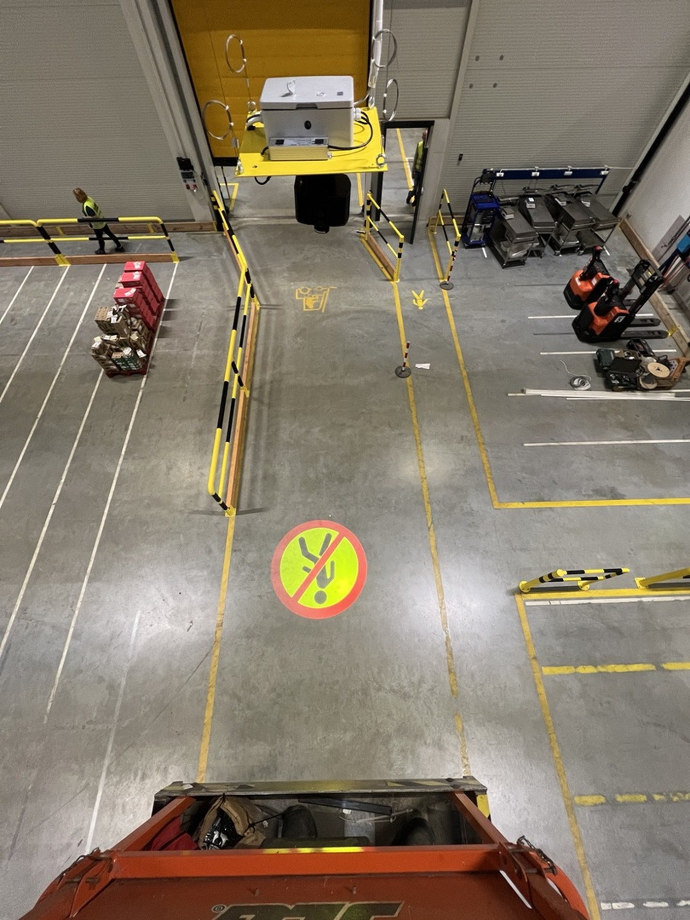 A Watch out! projector above a high-speed door; a round no-pedestrian sign glows on the floor below