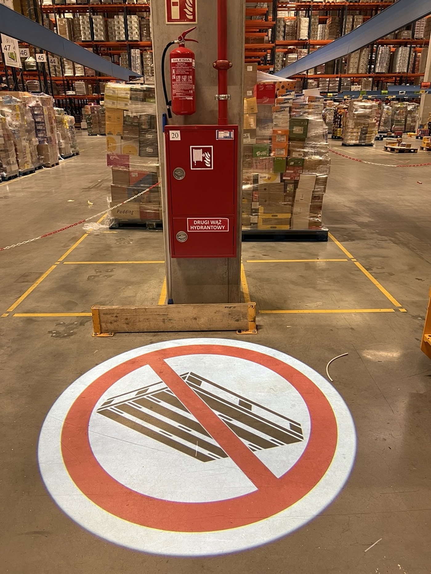 A no-storage sign projected in front of a fire hydrant cabinet, keeping access to firefighting equipment clear
